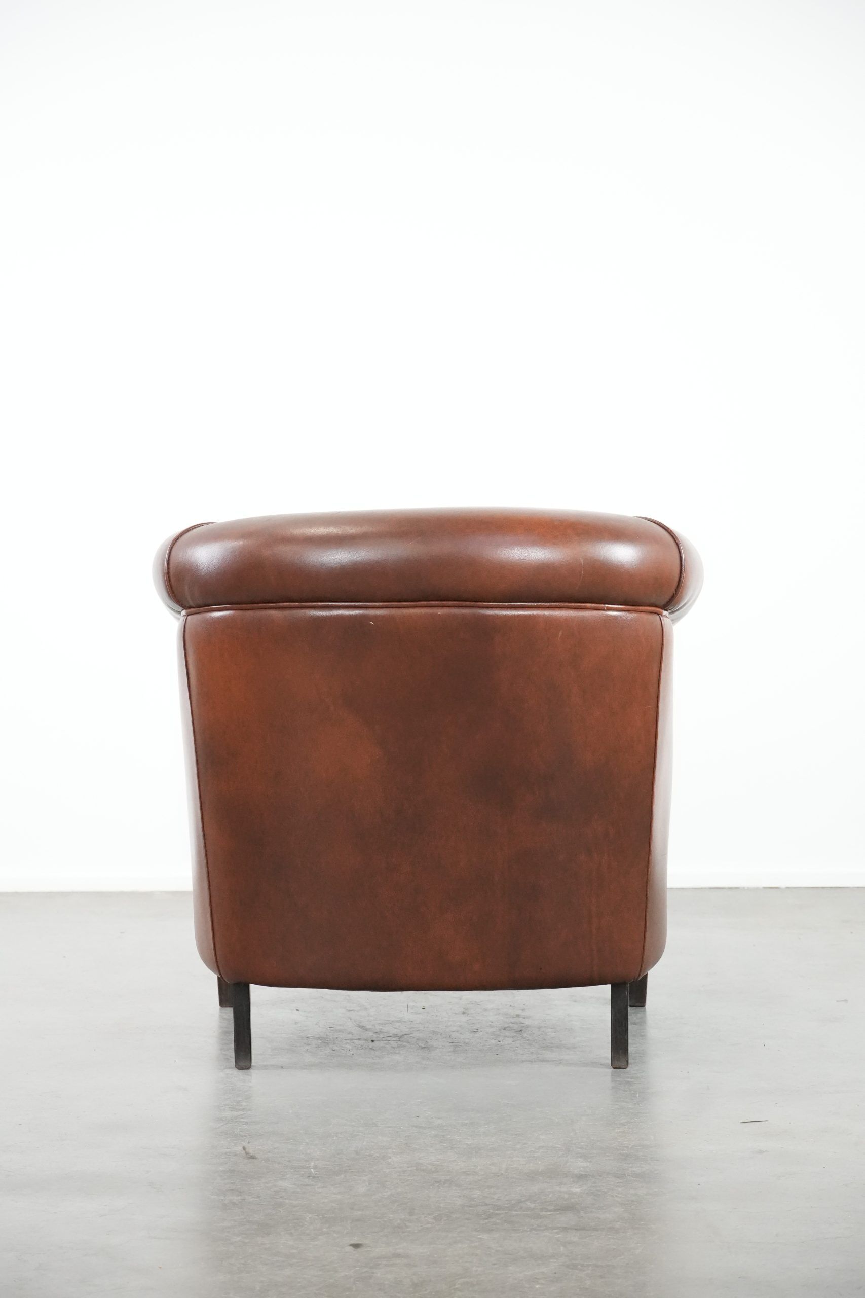 Cognac-coloured cow leather club armchair in English style