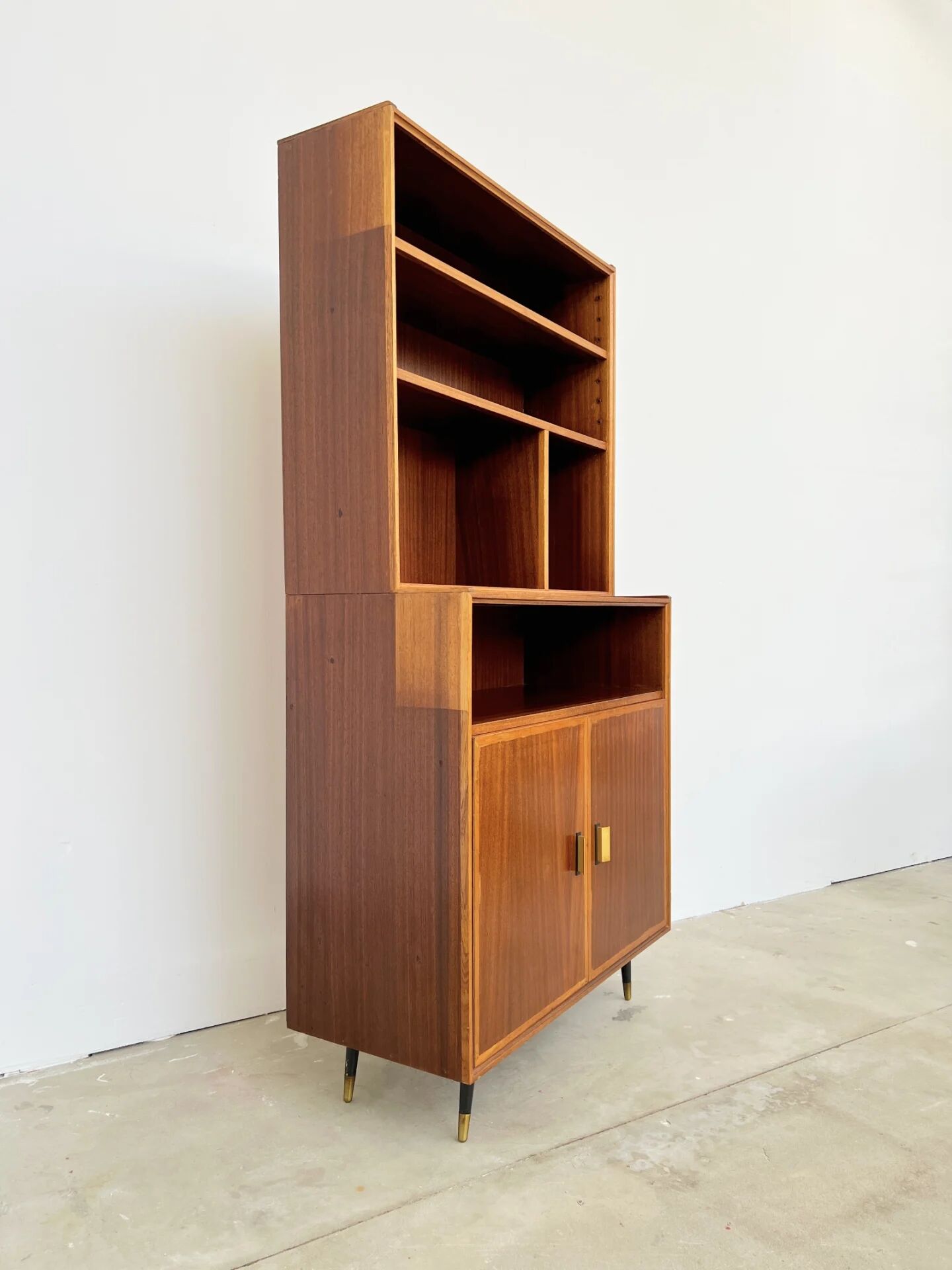 Mahogany library — closed storage and open cubbies, custom-made, 1960s.