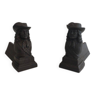 Pair of cast iron andirons in the likeness of a musketeer