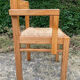 Brutalist chair in solid pine with a straw seat from the 1970s.