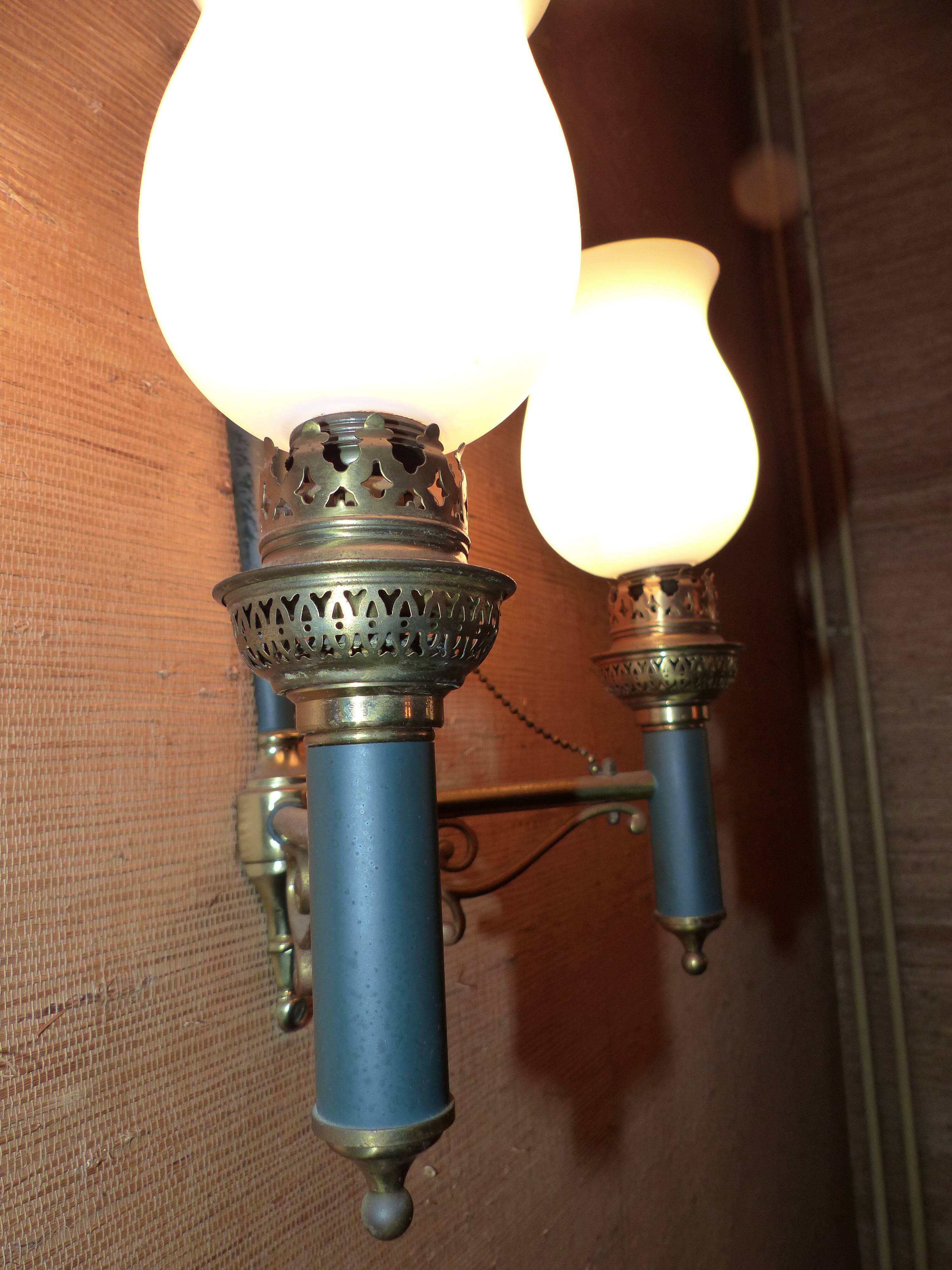 Brass wall sconce and frosted globe