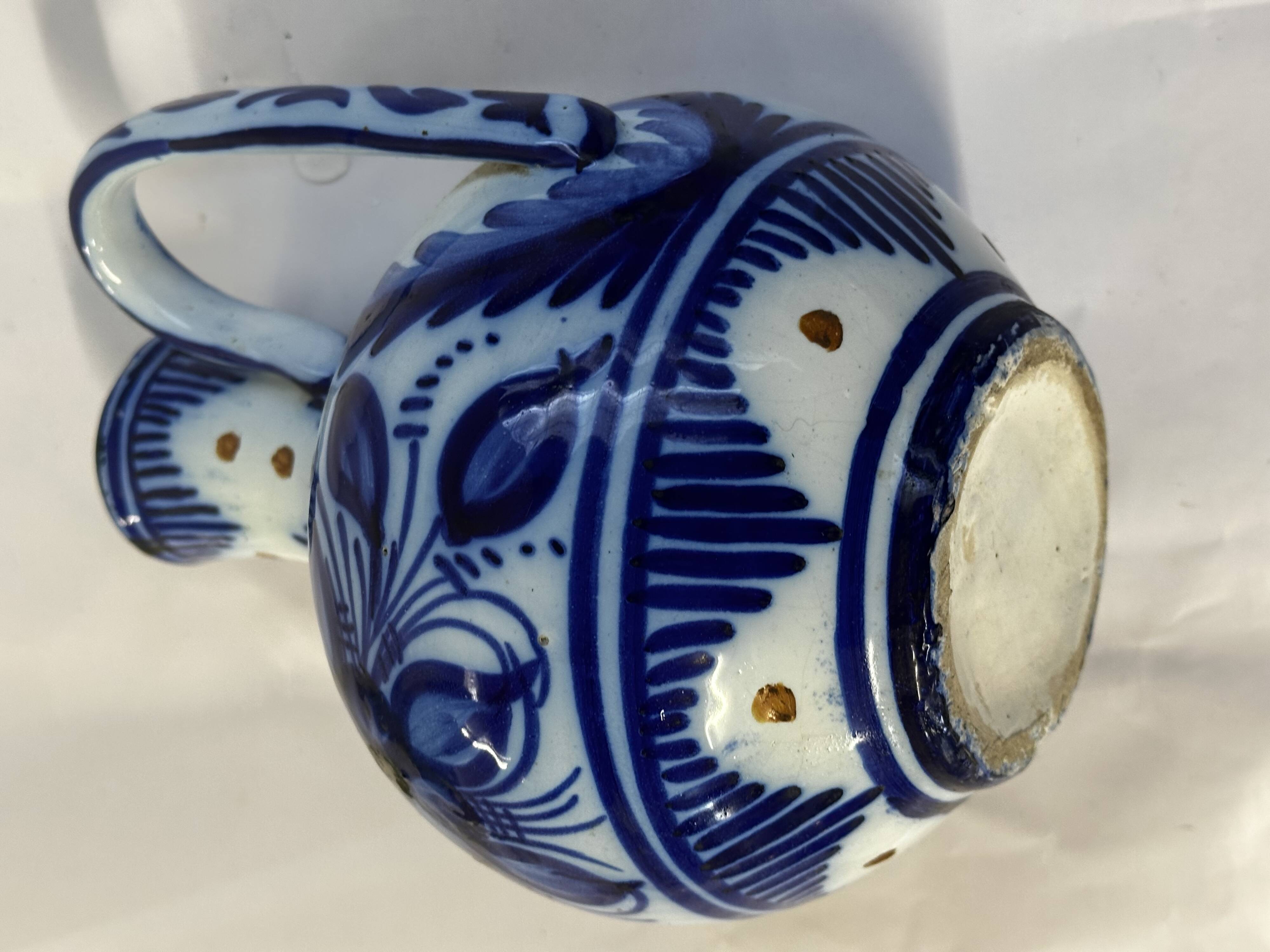 Glazed ceramic carafe with floral decoration