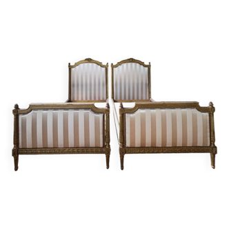 Pair of late 19th-century gilded wooden beds in Louis XVI style.