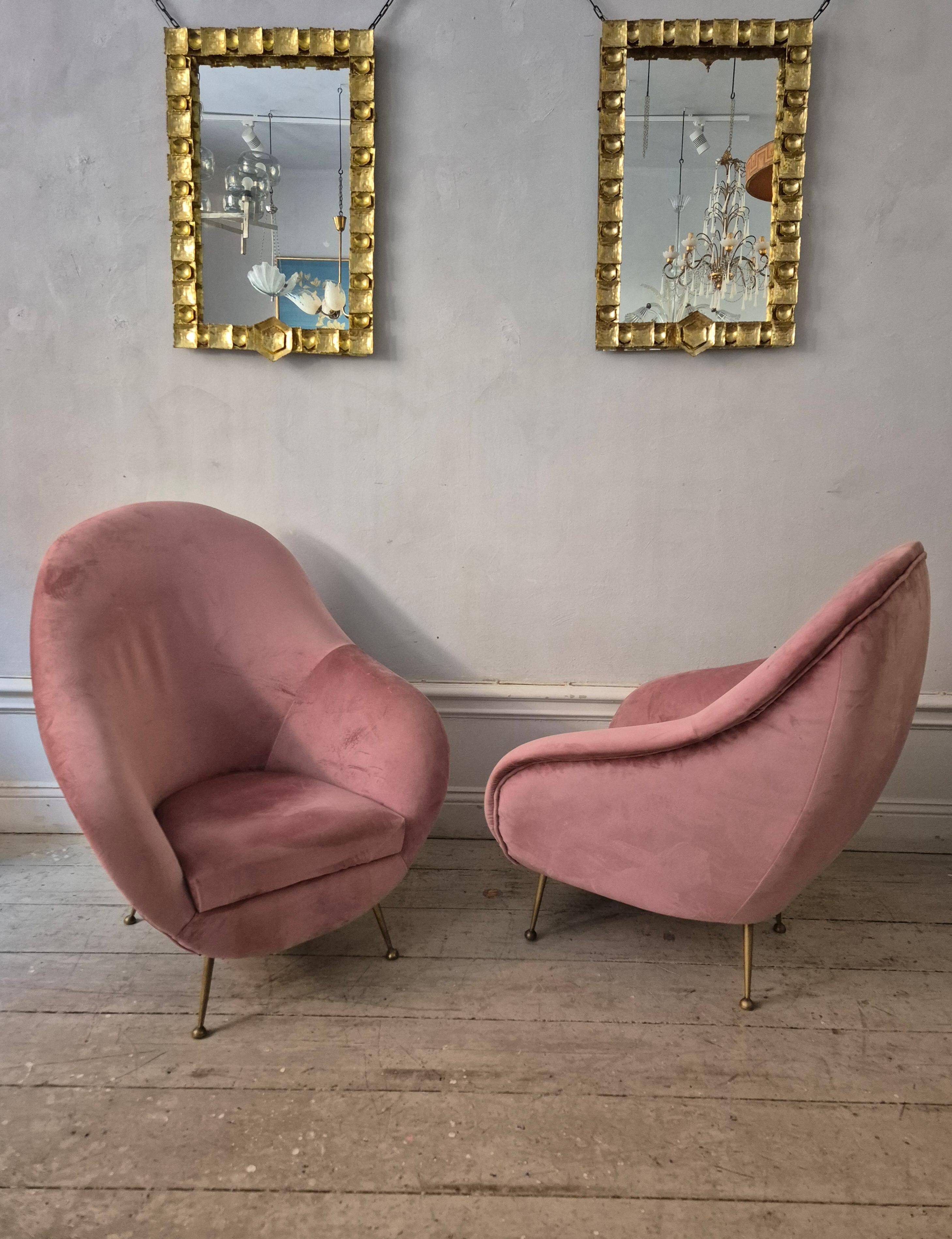 An elegant pair of armchairs with brass legs, Italy from the mid-20th century.