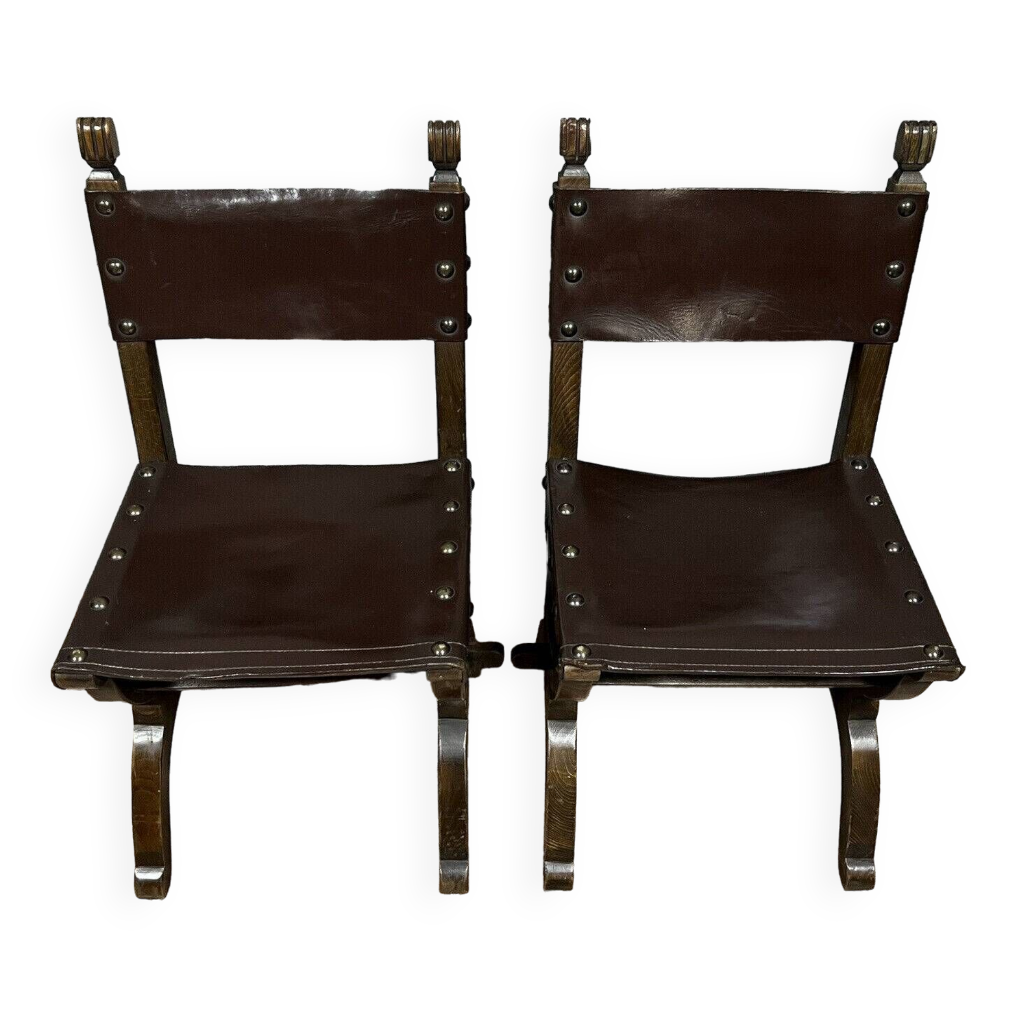 Pair of medieval style chairs in solid wood and leather, 19th century, circa 1850