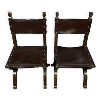 Pair of medieval style chairs in solid wood and leather from the 19th century circa 1850