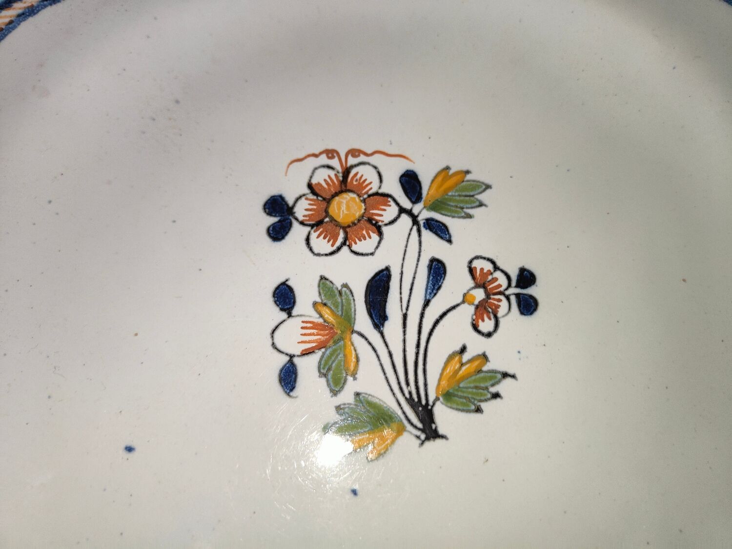 Old earthenware plate of the North XVIIIth Century with floral decoration