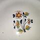 Old earthenware plate of the North XVIIIth Century with floral decoration
