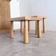 Two stools or small nesting tables in light oak.