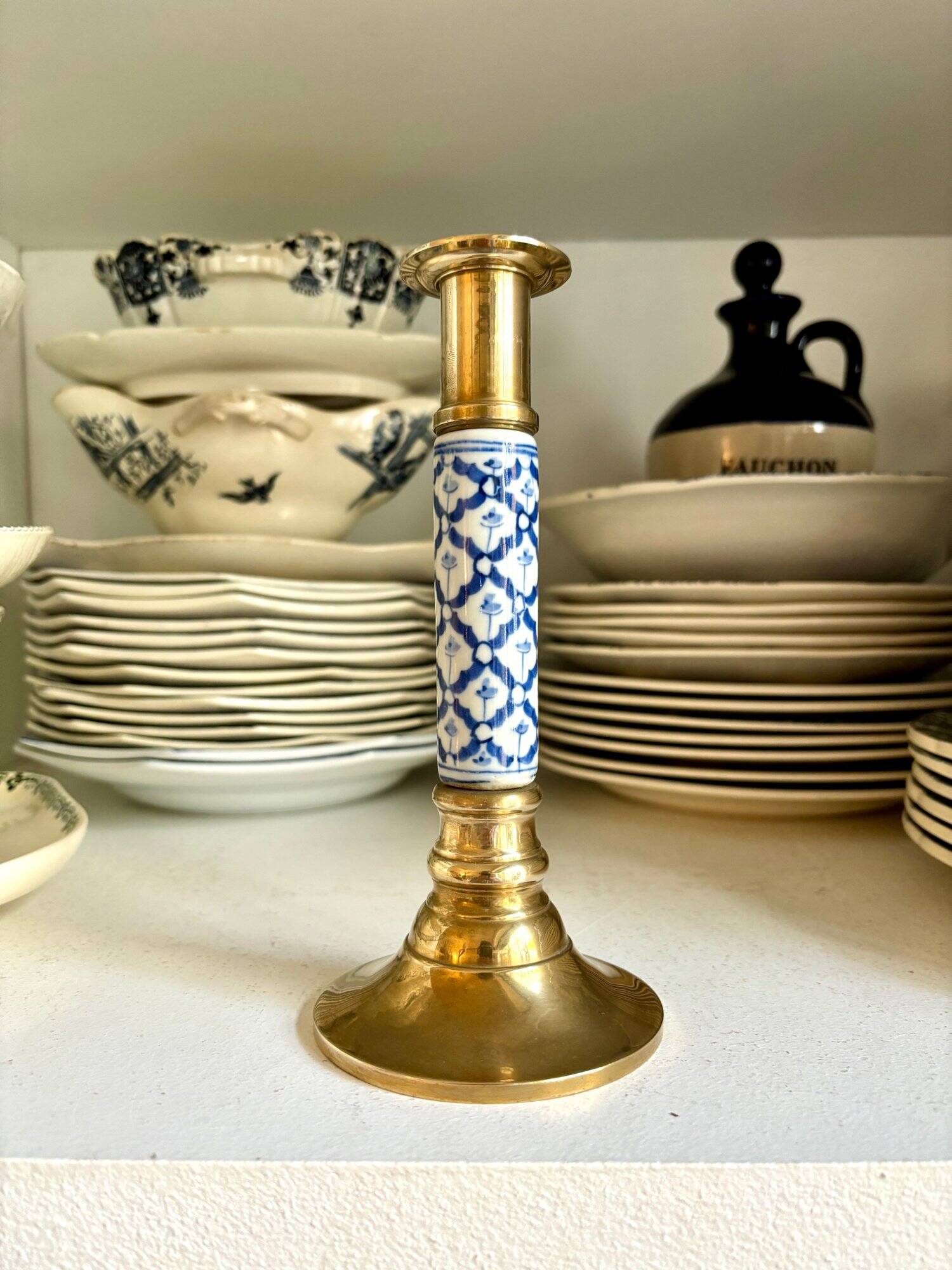 Candlestick in gilded brass and blue earthenware