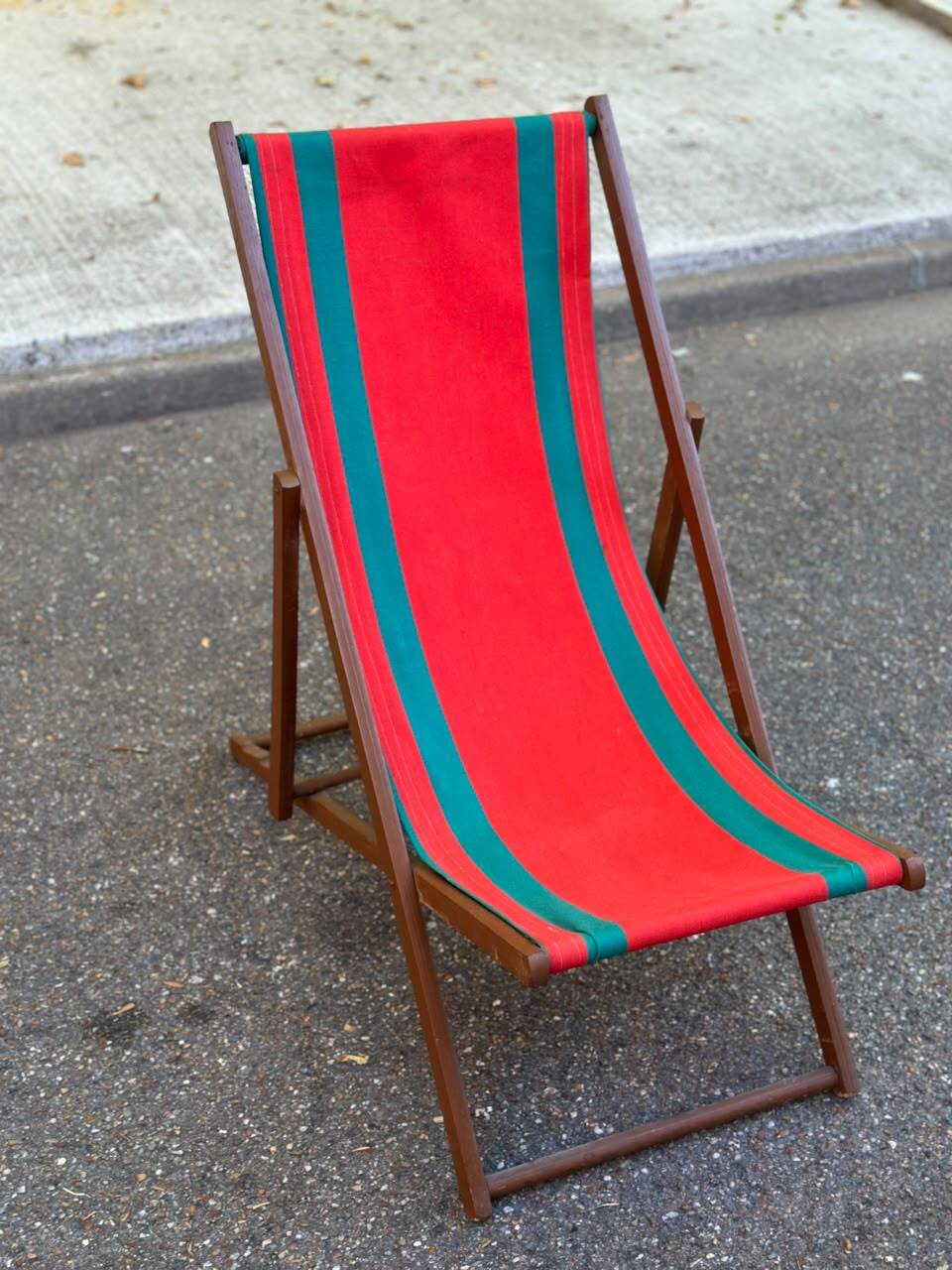 Vintage folding wooden deck chair with red and green striped canvas from the 1970s.