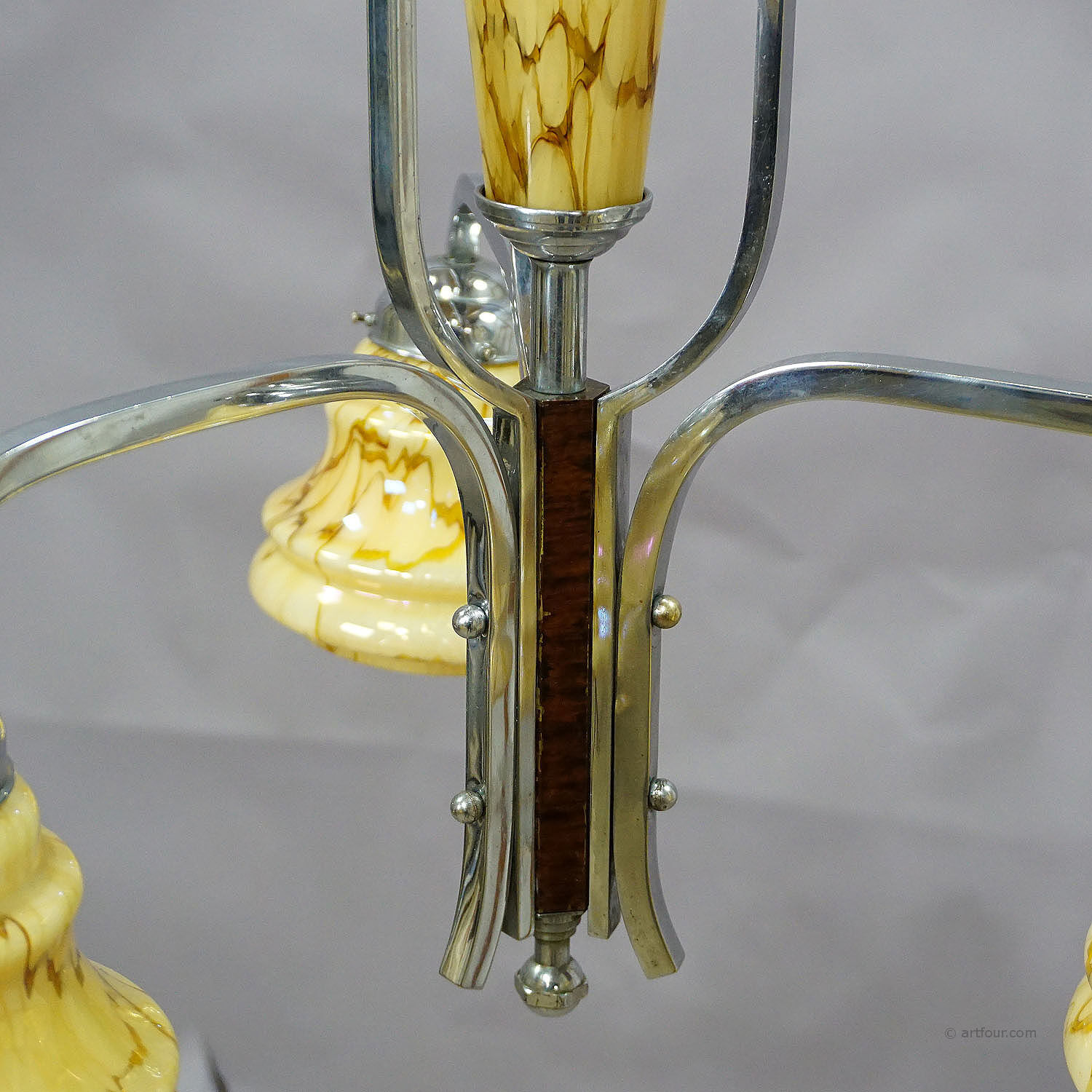 Antique Art Deco chandelier with three glass lampshades.
