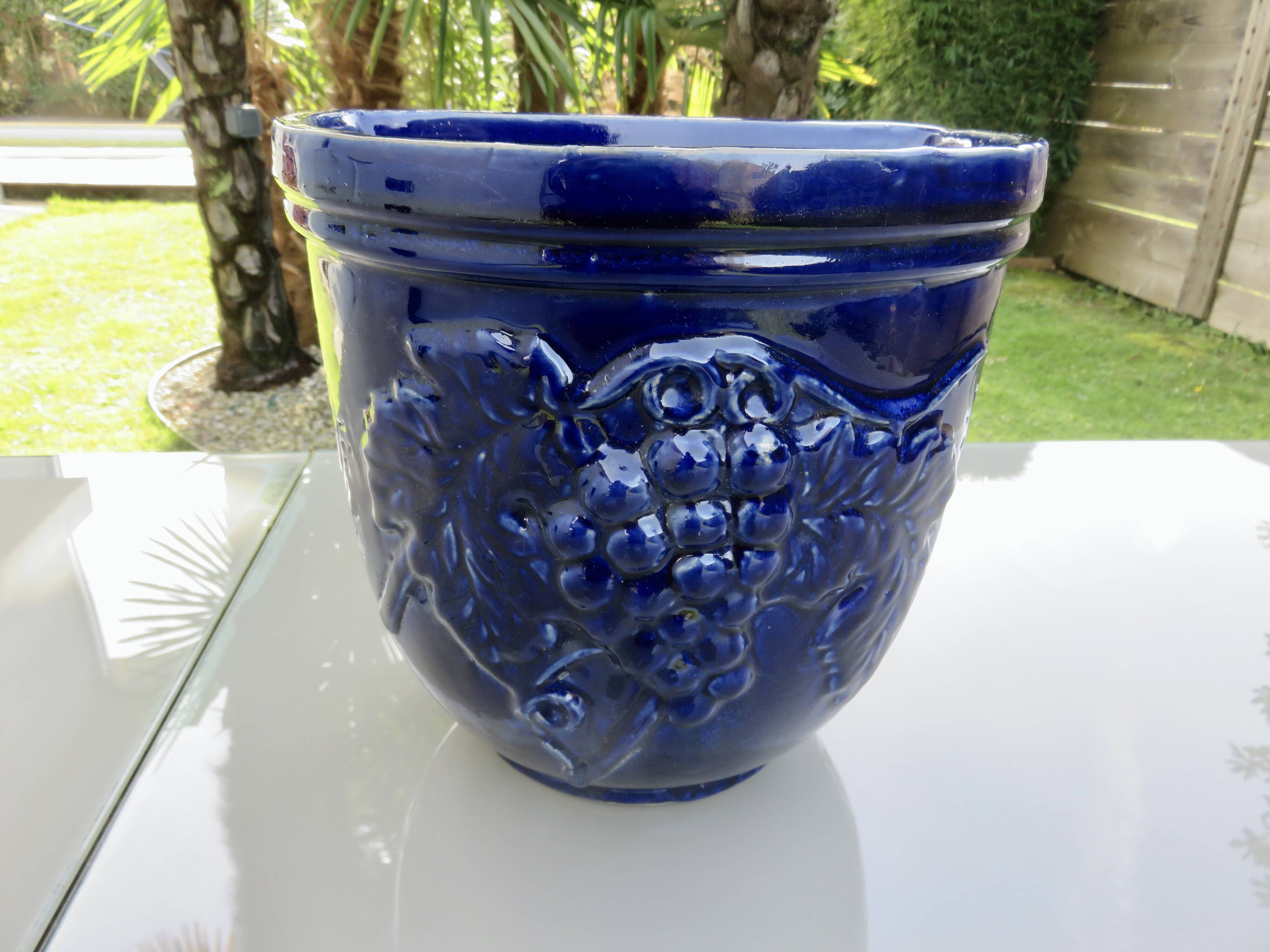 Wall pot in glazed blue terracotta with a grape motif, 1970s.