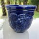 Wall pot in glazed blue terracotta with a grape motif, 1970s.