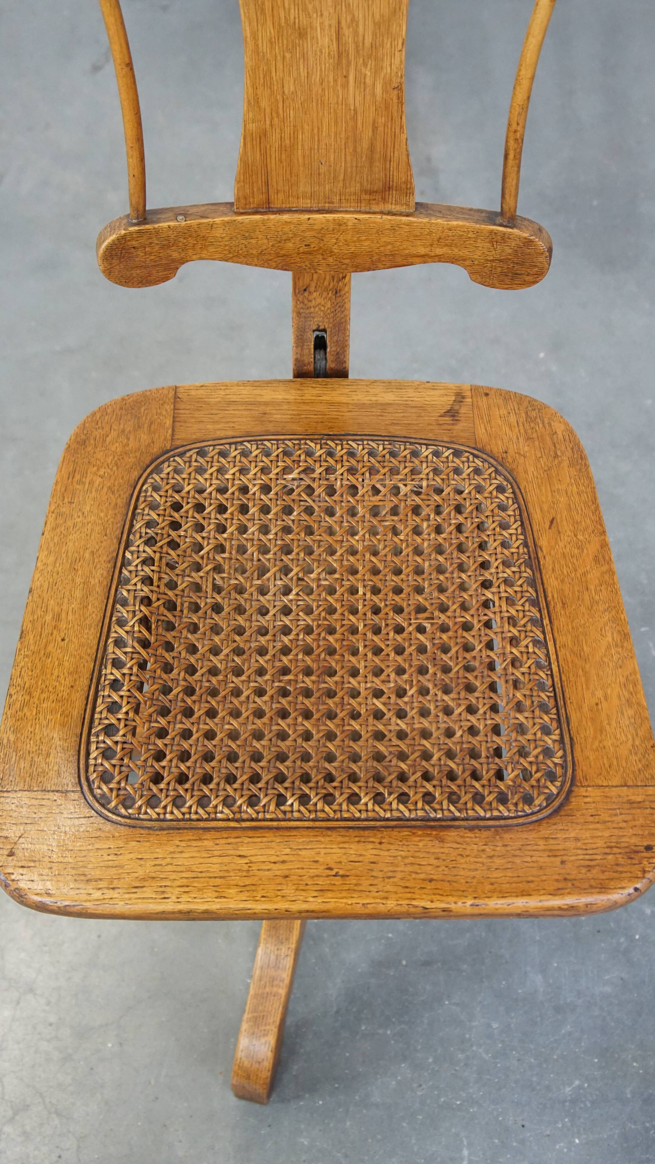 Antique late 19th century English office chair with reclining backrest and height adjustable