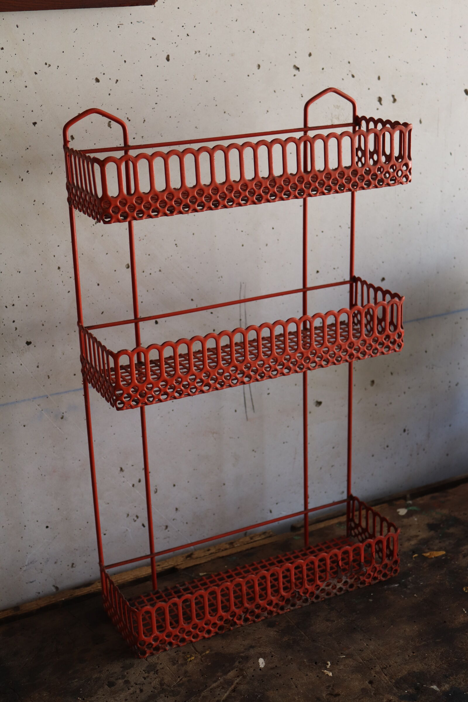 Vintage shelf in red openwork metal