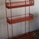 Vintage shelf in red openwork metal