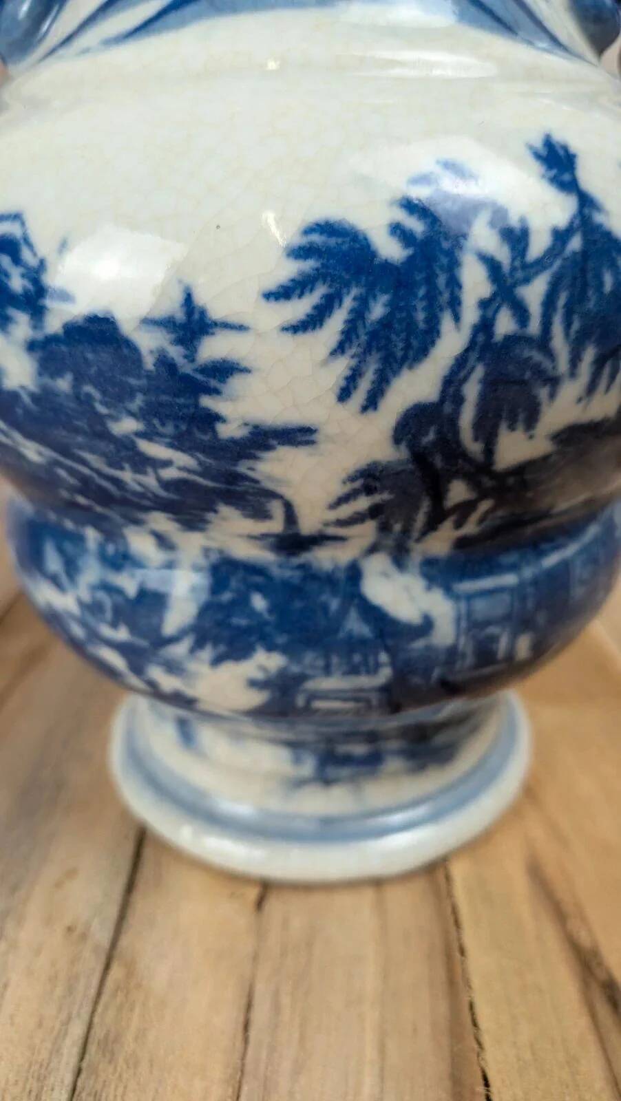 Blue and white Chinese vase with sculpted handles and landscape decoration.