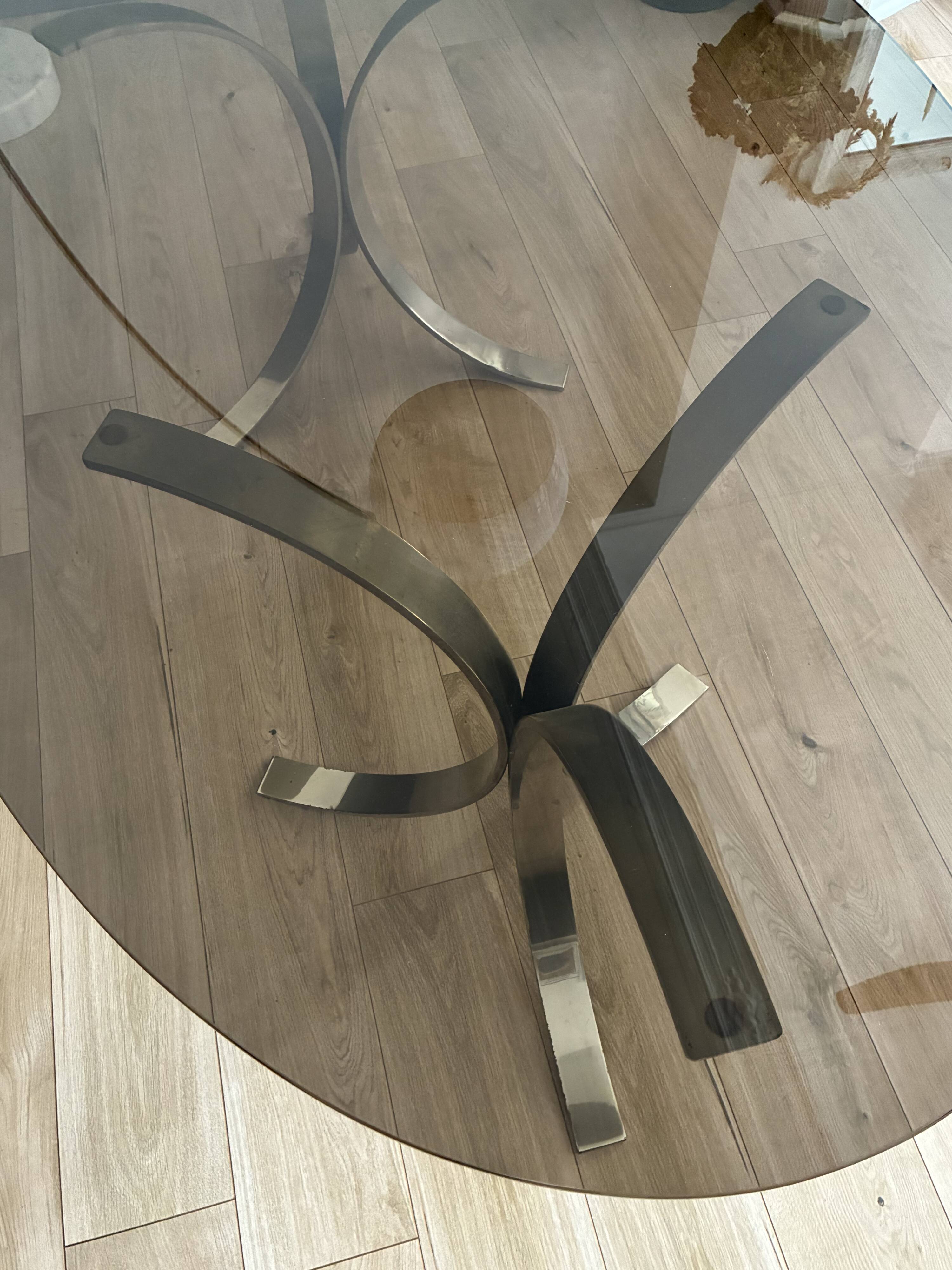 Smoked glass table with a metal base.