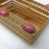 Empty pocket in gold metal and pink stones