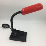 Duo of red and black flexible desk lamps with pencil holder