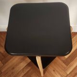 Black lacquered wooden side table with offset tops.