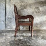 Small antique Indonesian bench in carved teak with plant and floral motifs.