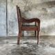 Small antique Indonesian bench in carved teak with plant and floral motifs.