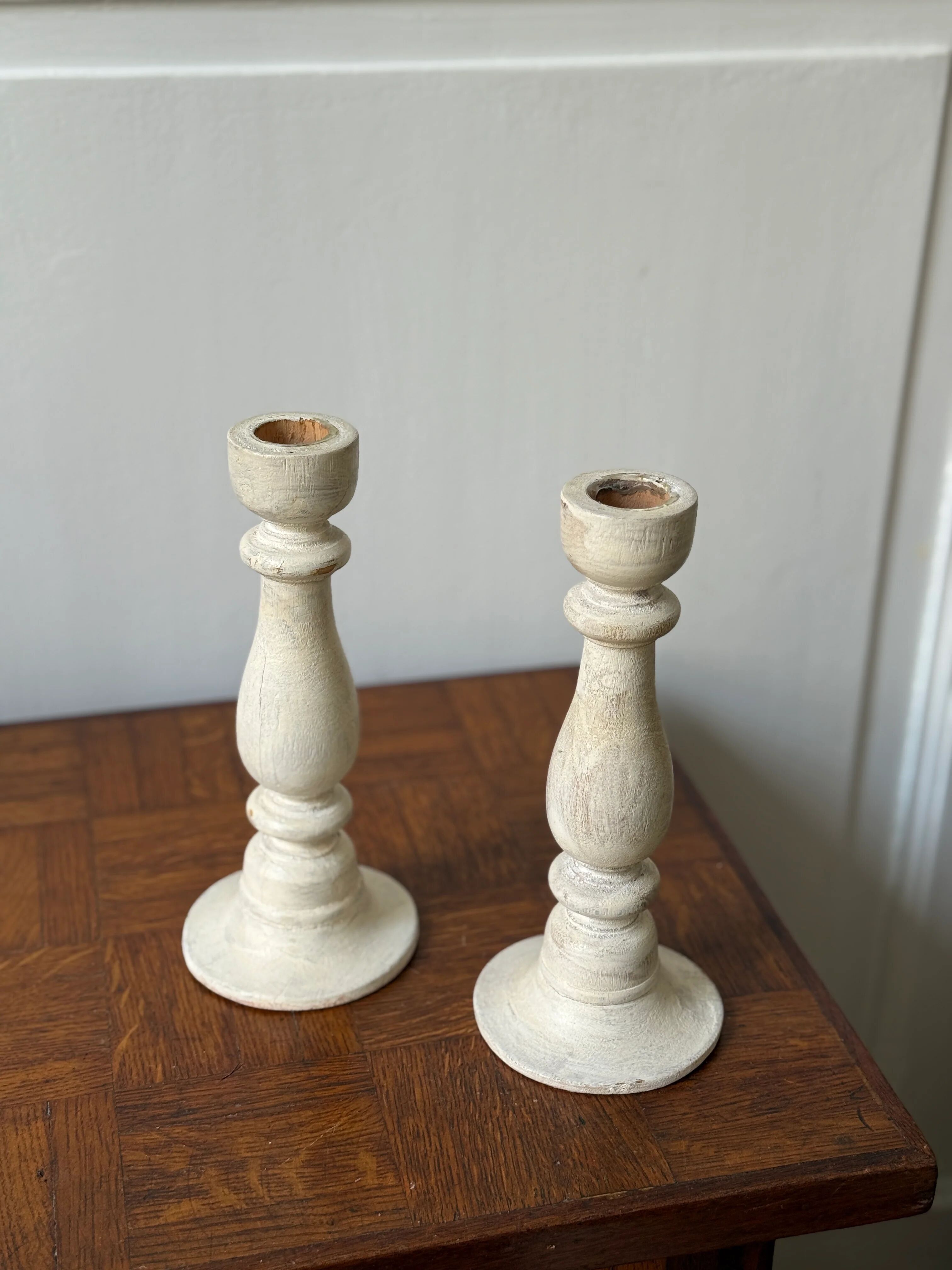 Pair of white wooden candlesticks
