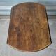 Antique round farmhouse table with drop-leaf doors in solid pegged wood