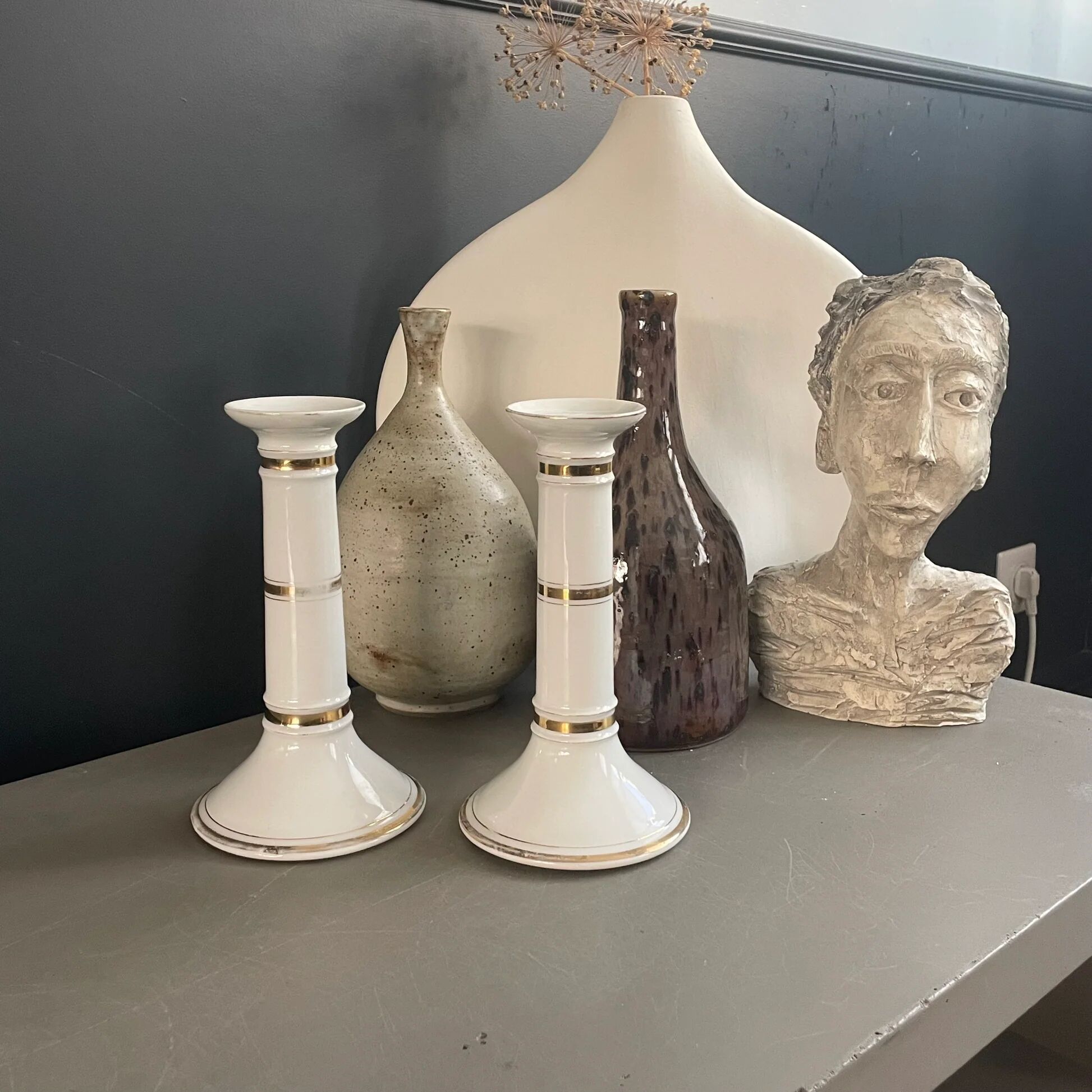 Pair of porcelain candlesticks with a gold pattern.