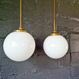Pair of Art Deco pendant lights in brass and white opaline, 1920-30