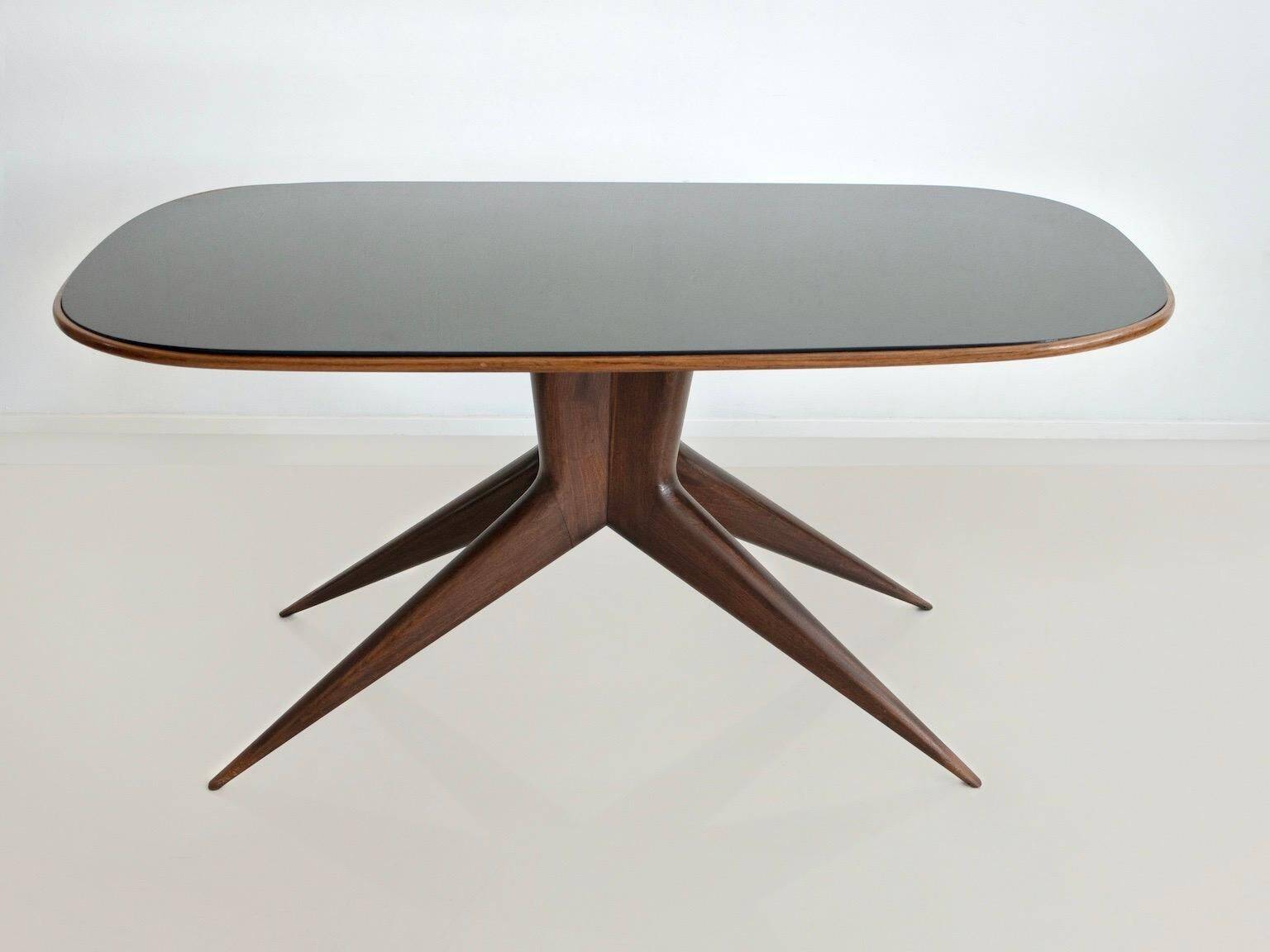 Dining table with a wooden frame and tinted glass top.
