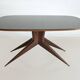 Dining table with a wooden frame and tinted glass top.