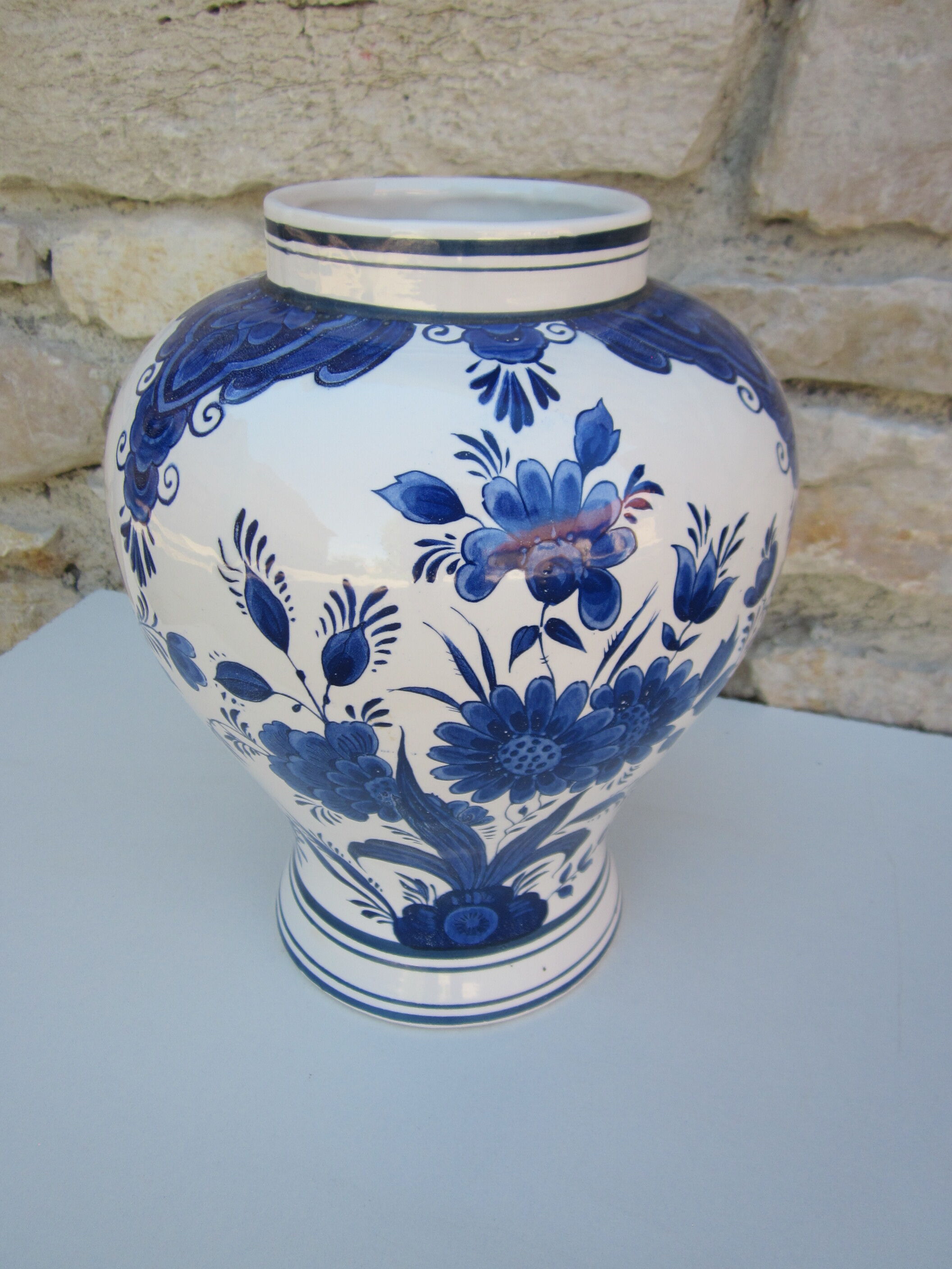 Ceramic vase earthenware, blue floral decoration on a white background
