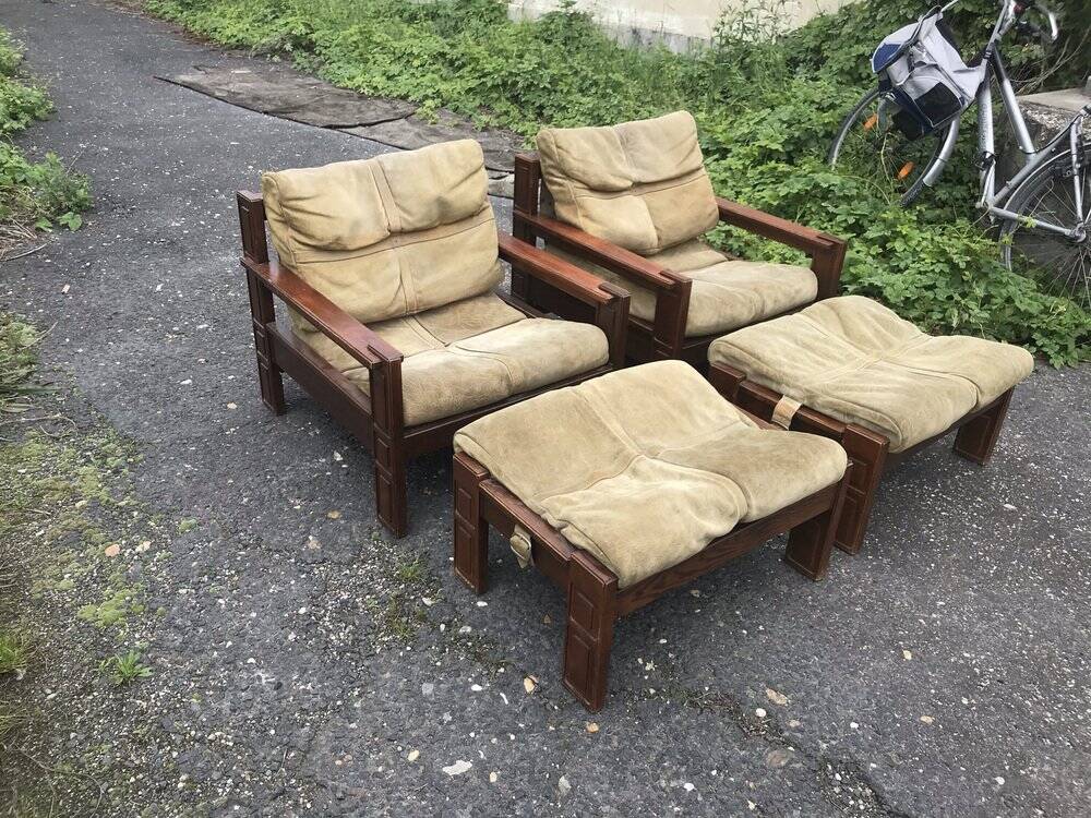 Set of 4 brown leather and wood armchairs with footstools, vintage 1960s style.