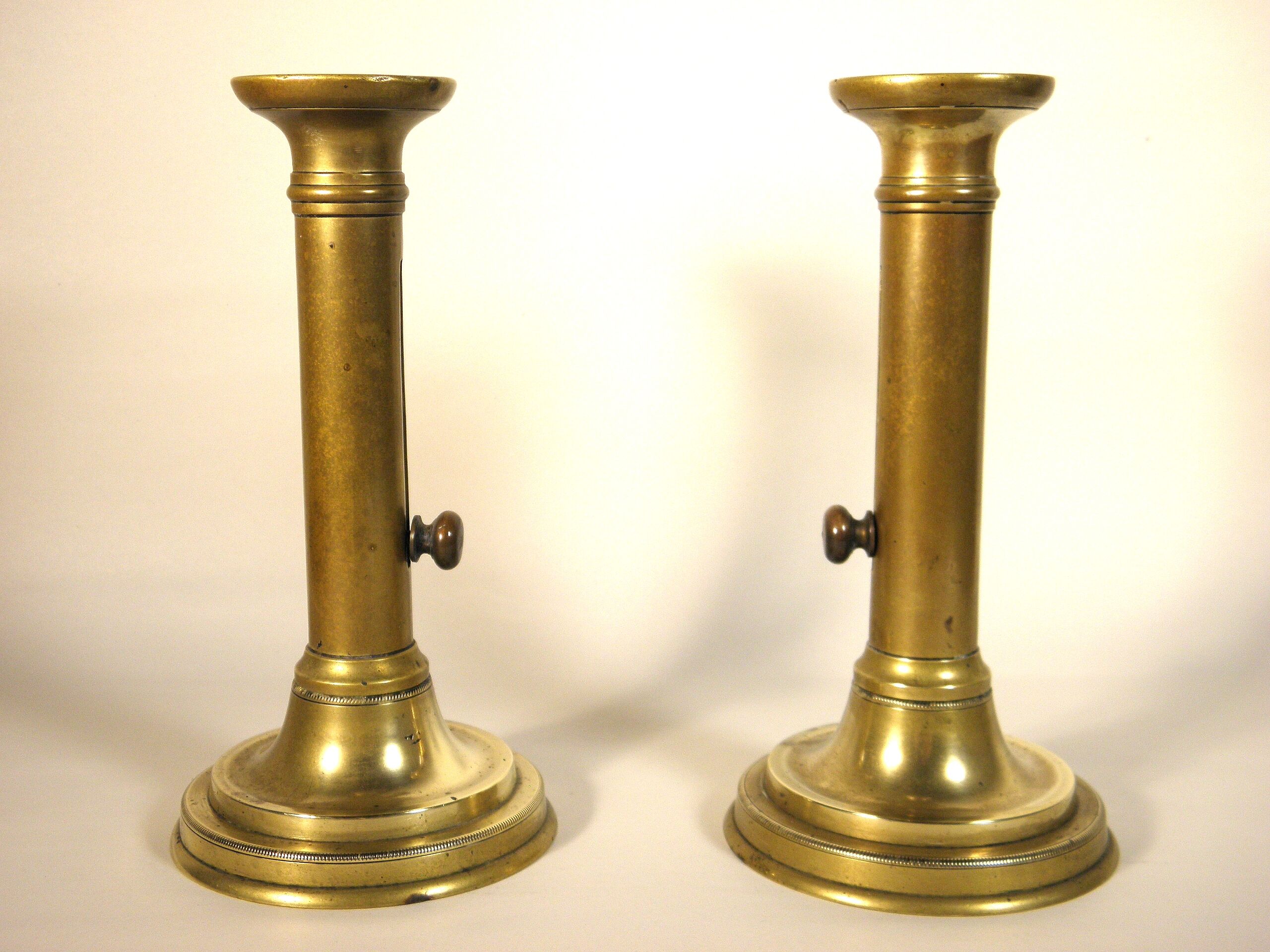 Pair of brass push candlesticks
