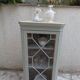 Vintage English corner display cabinet enhanced in grey-green with a wooden top.