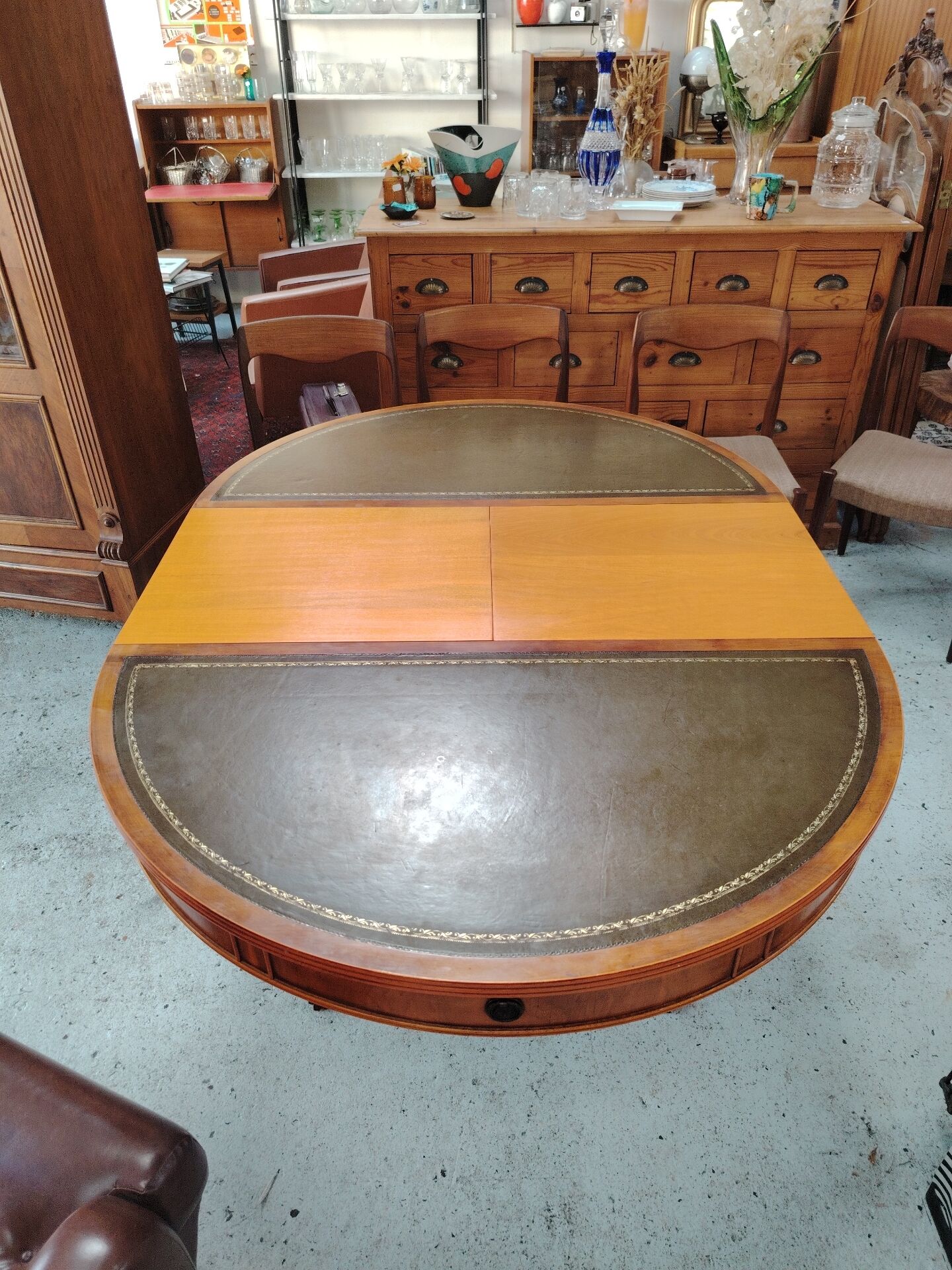 Round Regency dining table in mahogany and green leather with extensions - 20th century