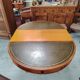 Round Regency dining table in mahogany and green leather with extensions - 20th century