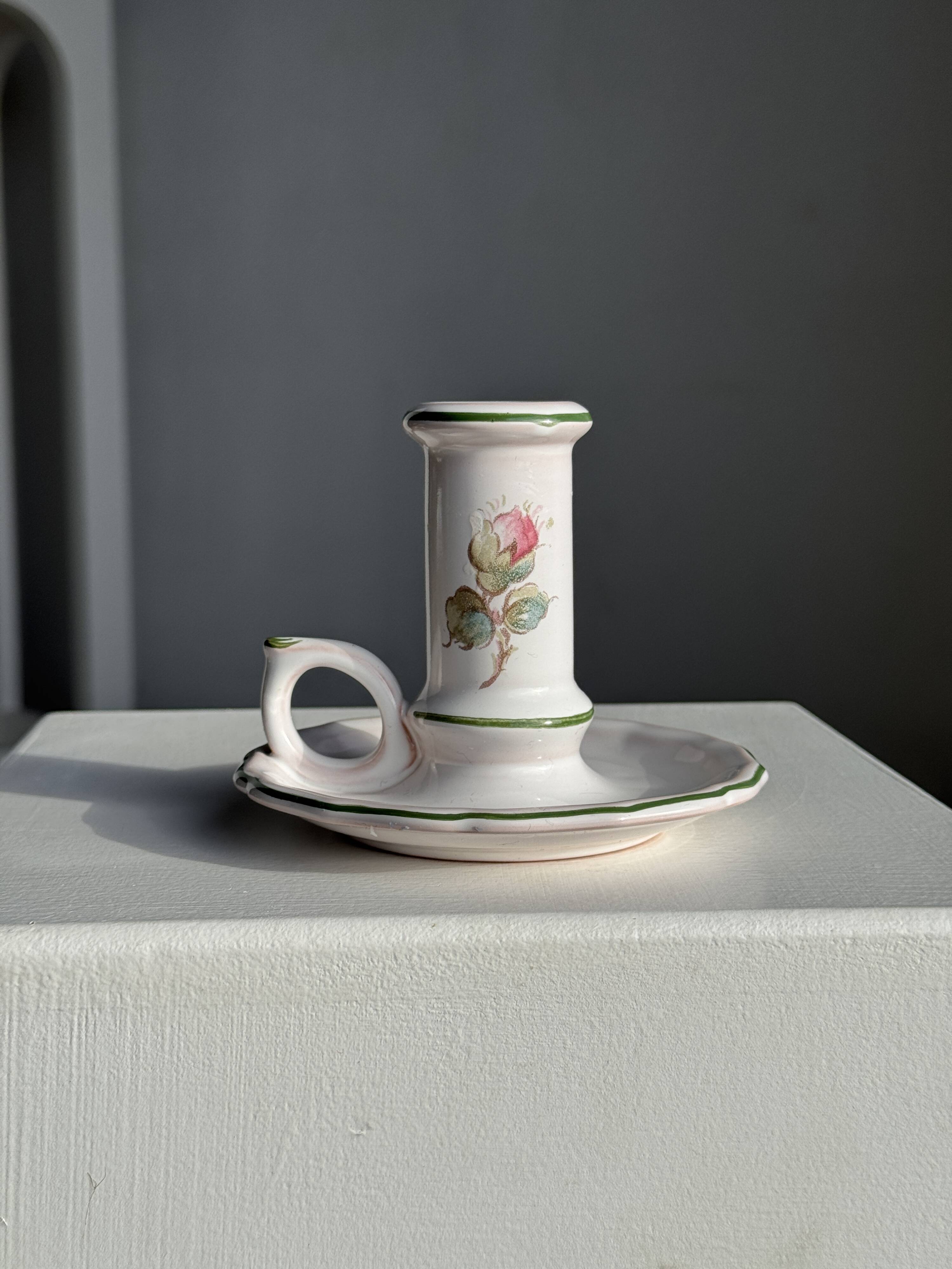 Small vintage hand-held candlestick in earthenware with green trim and floral decoration H10.5