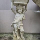 Antique reconstituted stone planter depicting a cherub