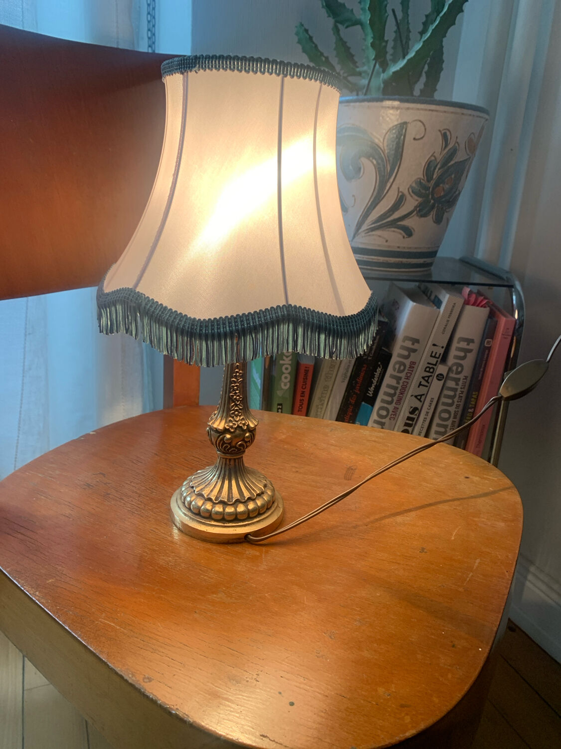 Vintage Neo-Rococo bedside lamp with fringed shade.