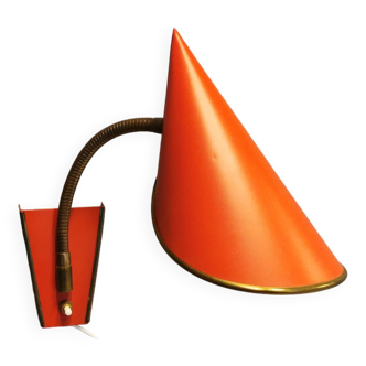 Danish red lacquered wall light with brass details. Estimated 1980s