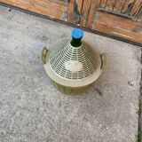 Large green glass lady-Jeanne in a khaki plastic basket, mid-century style.