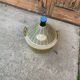 Large green glass lady-Jeanne in a khaki plastic basket, mid-century style.