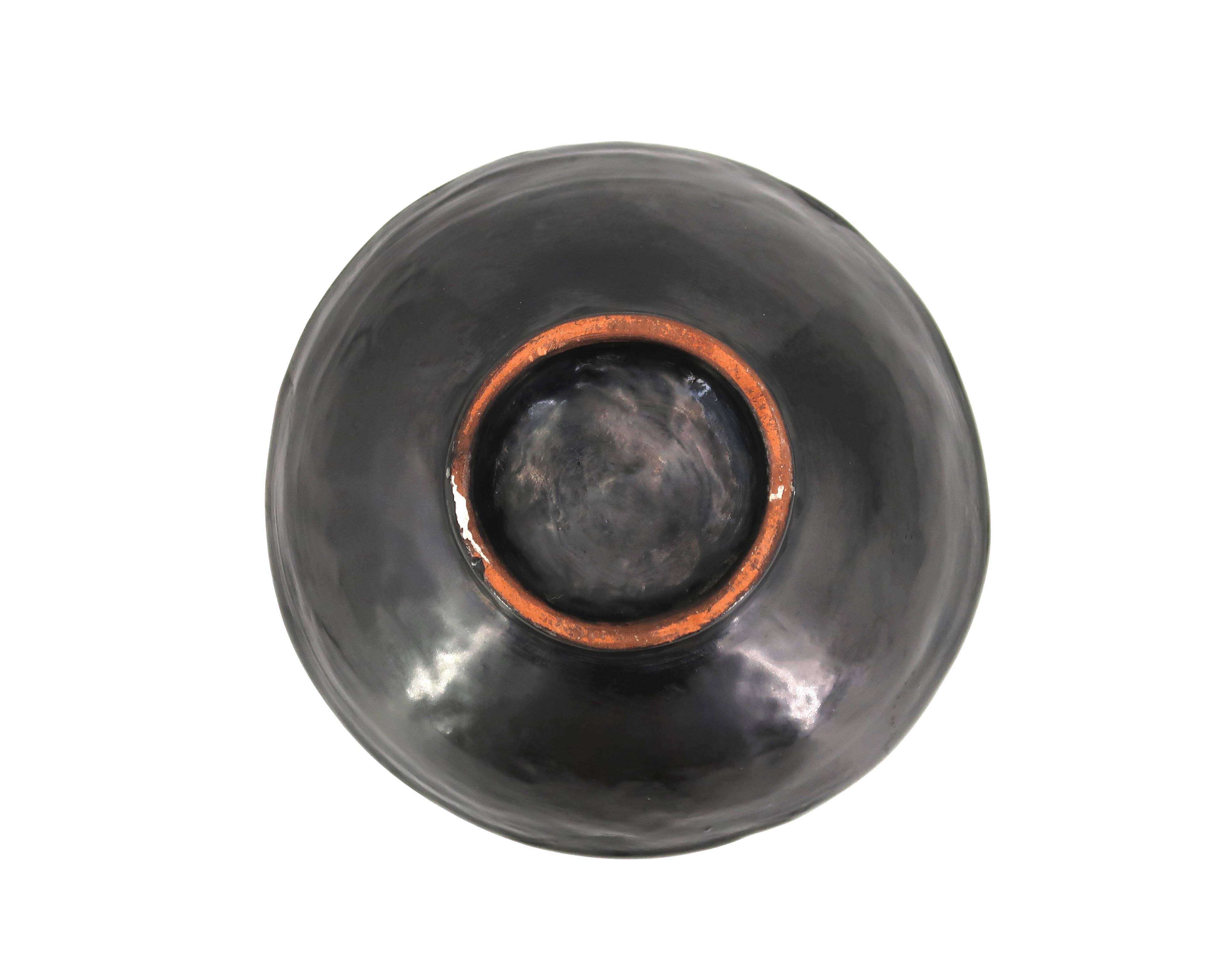 Mexican ceramic catchall in orange and black, 1970s sun face.
