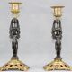 Pair of candle holders in gilded bronze and patinated with a candle