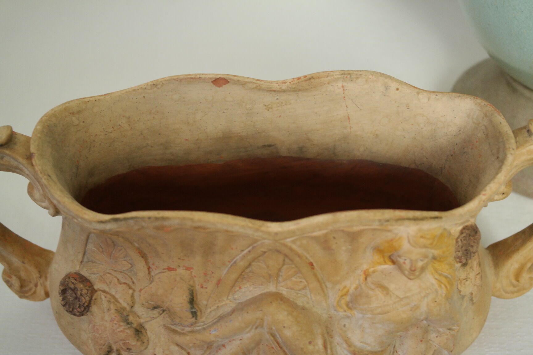 Art Nouveau jardinière with bas-reliefs in terracotta.