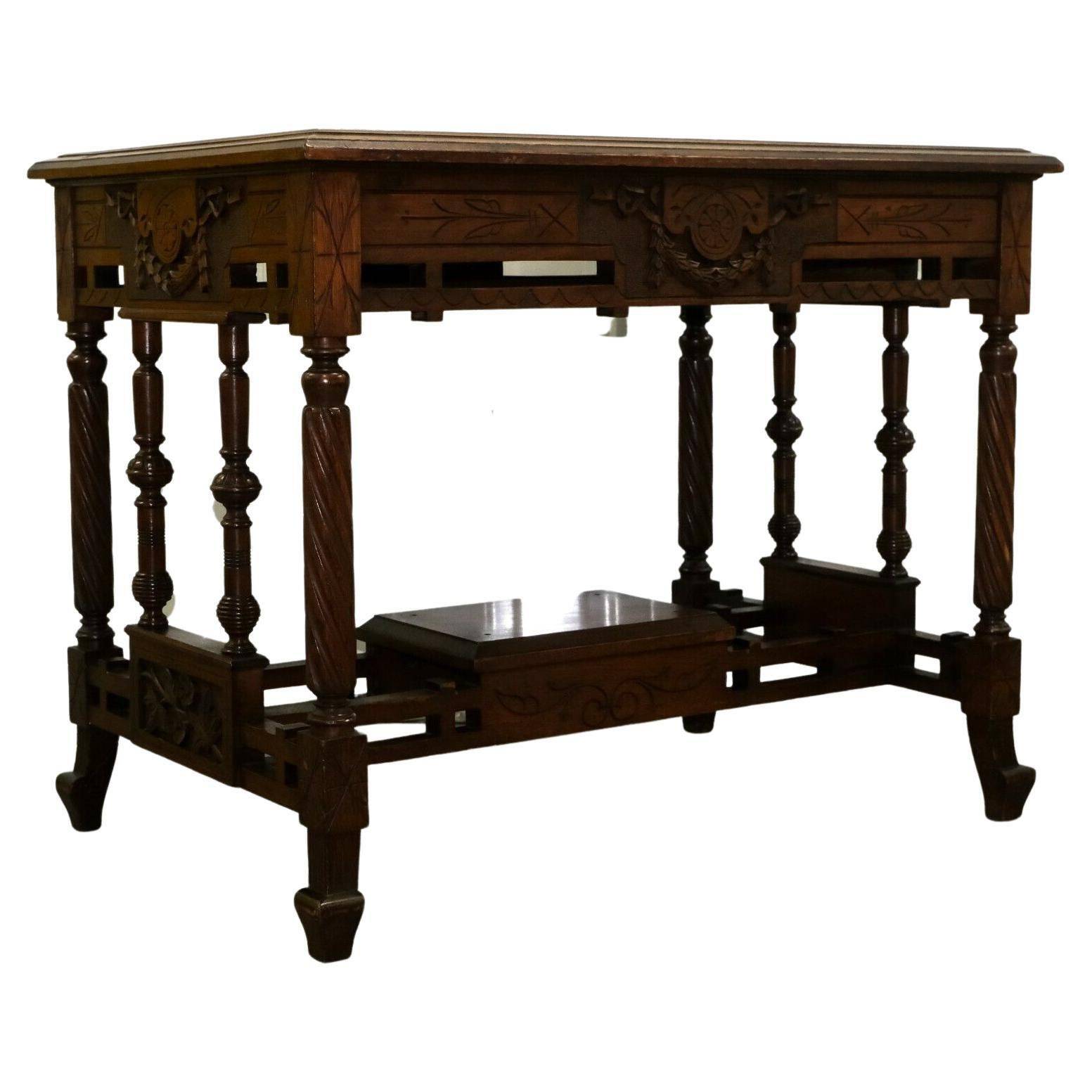 19th-century carved walnut desk with a leather top.